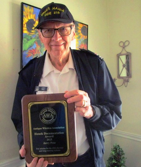 Jerry Proc holding the Antique Wireless Association Houck Documentation Award plaque for 2025